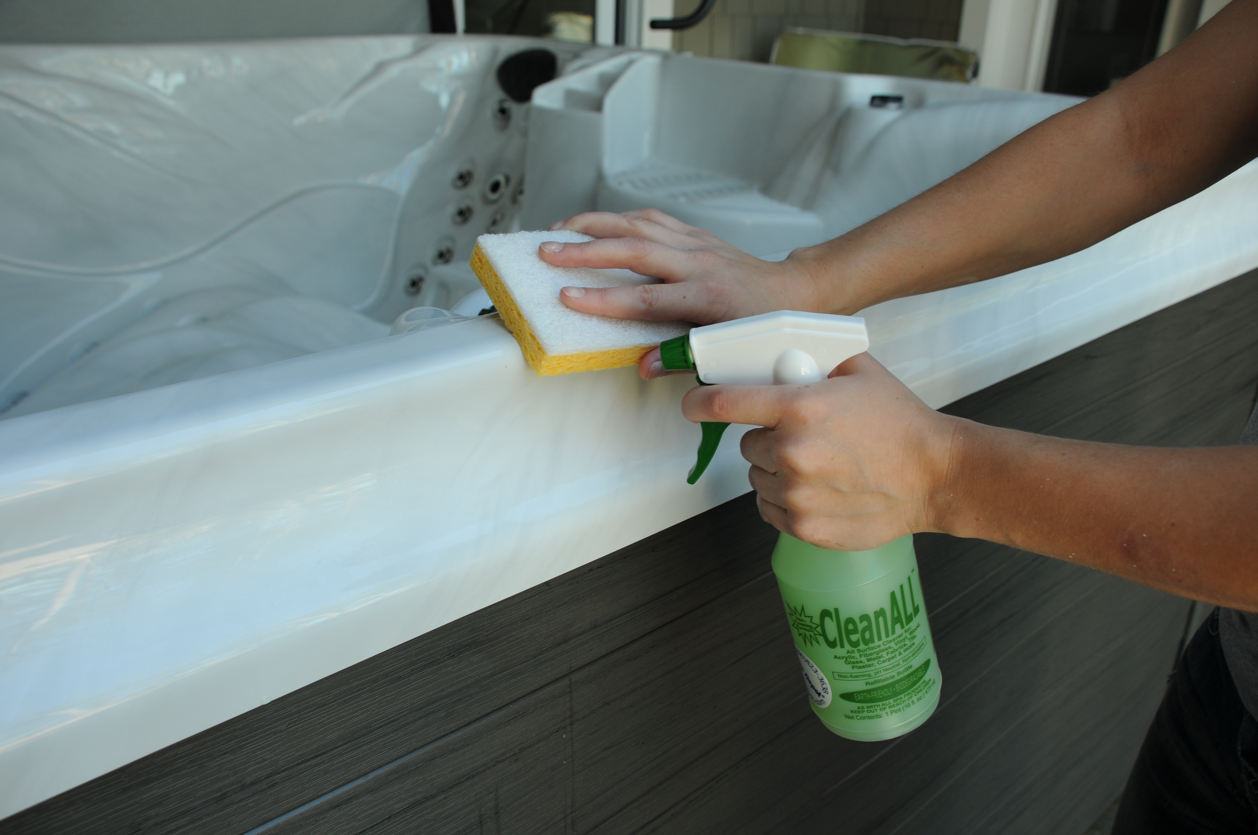 wiping spa shell with sponge and clean all spray