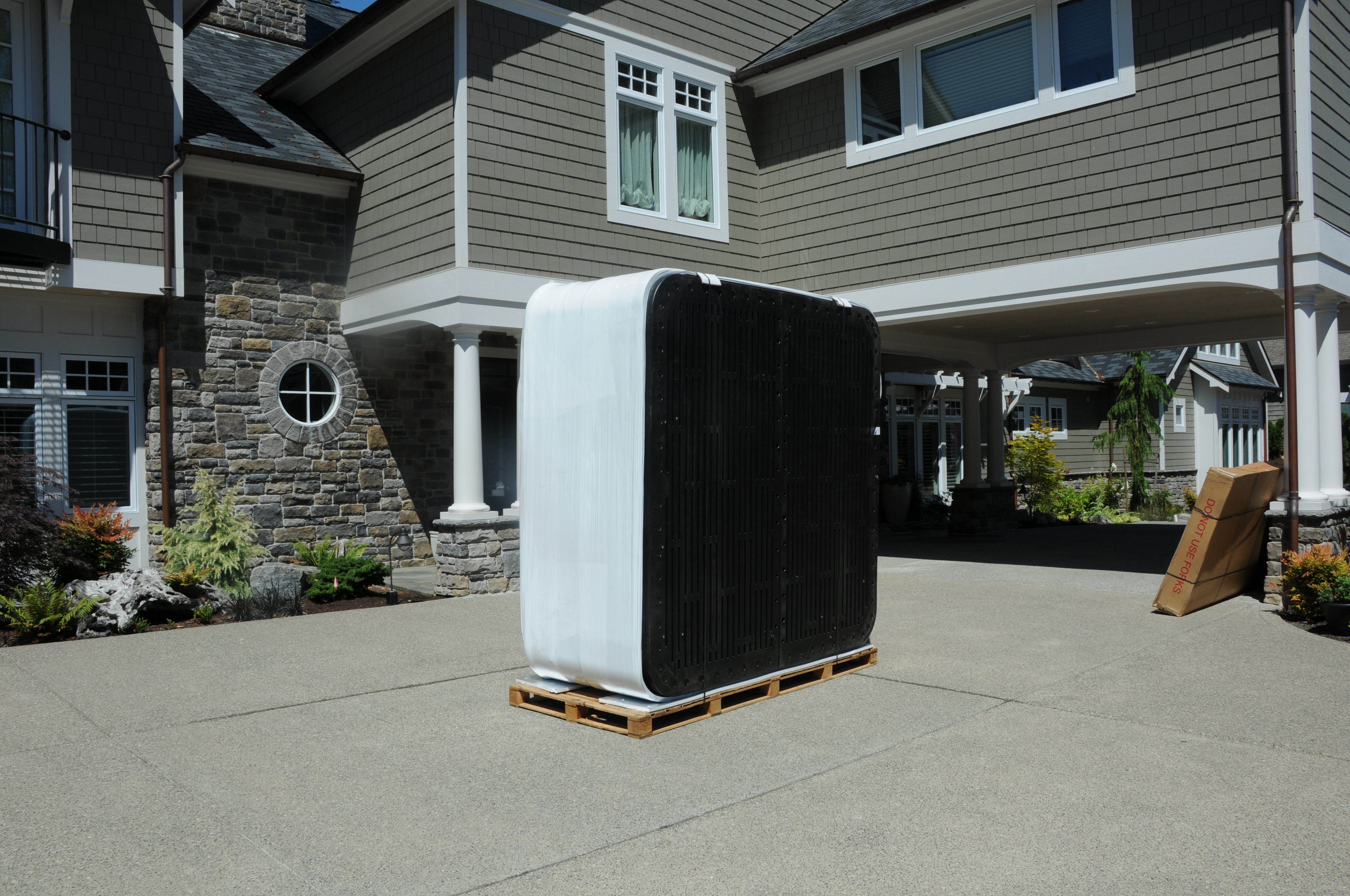 Hot tub standing on its side, on top of a pallet