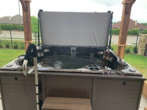 hot tub with handrail and steps